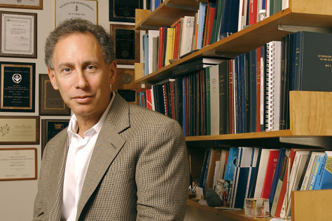 Robert Langer in front of a bookshelf