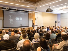 man gives lecture in an auditorium